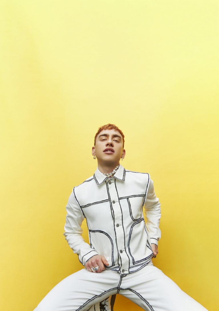 Olly Alexander Posing With Yellow Background