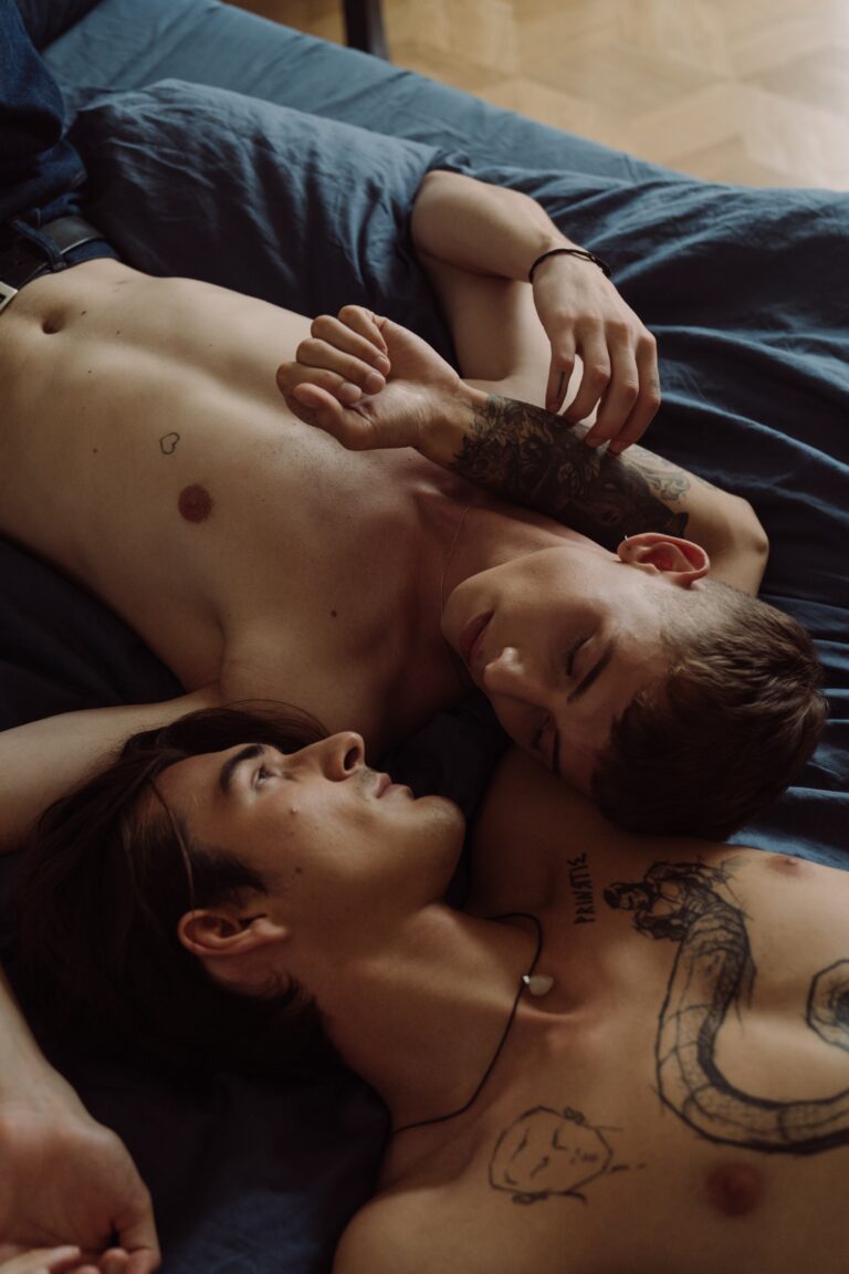 Photo of two men in bed.